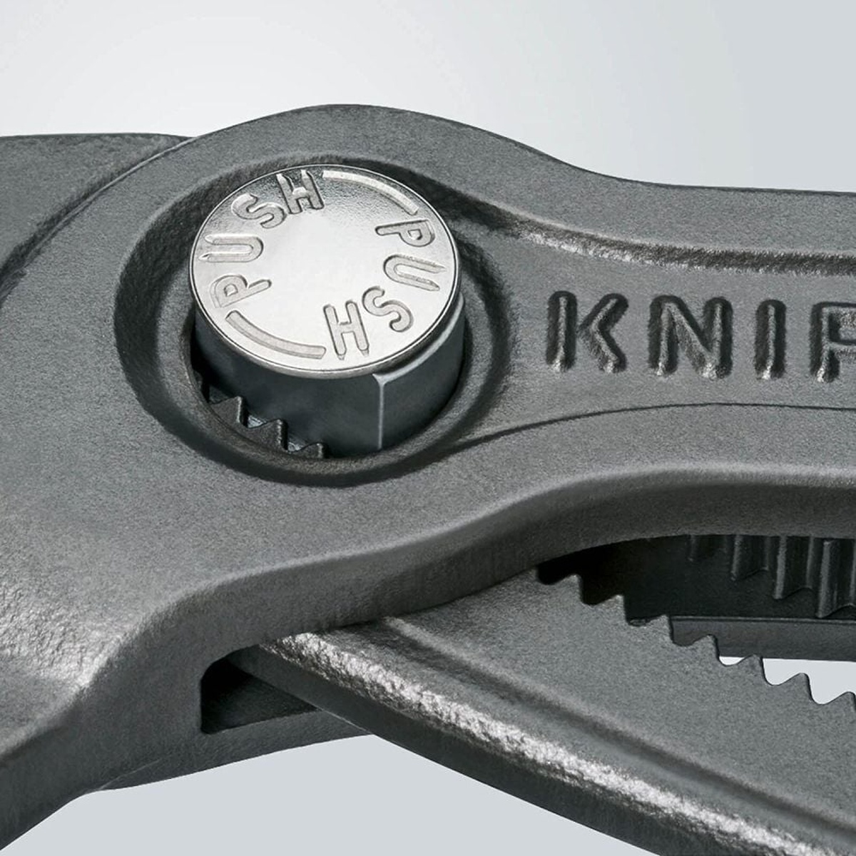 Close-up of the push-button adjustment on Knipex Cobra Hightech Water Pump Pliers 150mm showing the jaw setting mechanism for quick size changes