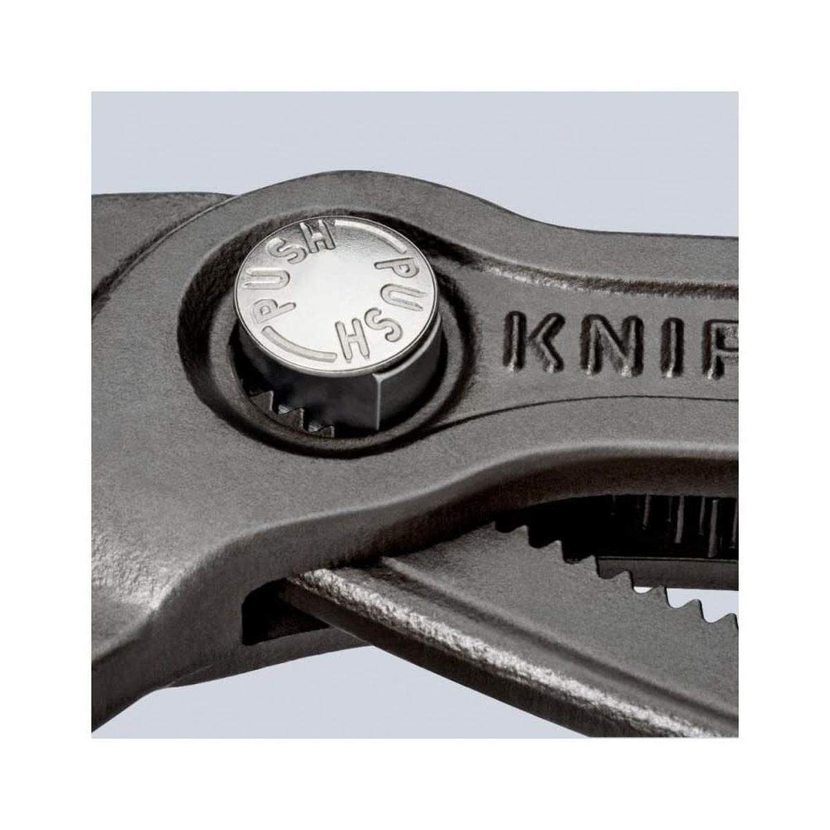 Close-up of the Knipex Cobra 12 in. Water Pump Pliers push-button adjustment at the box joint