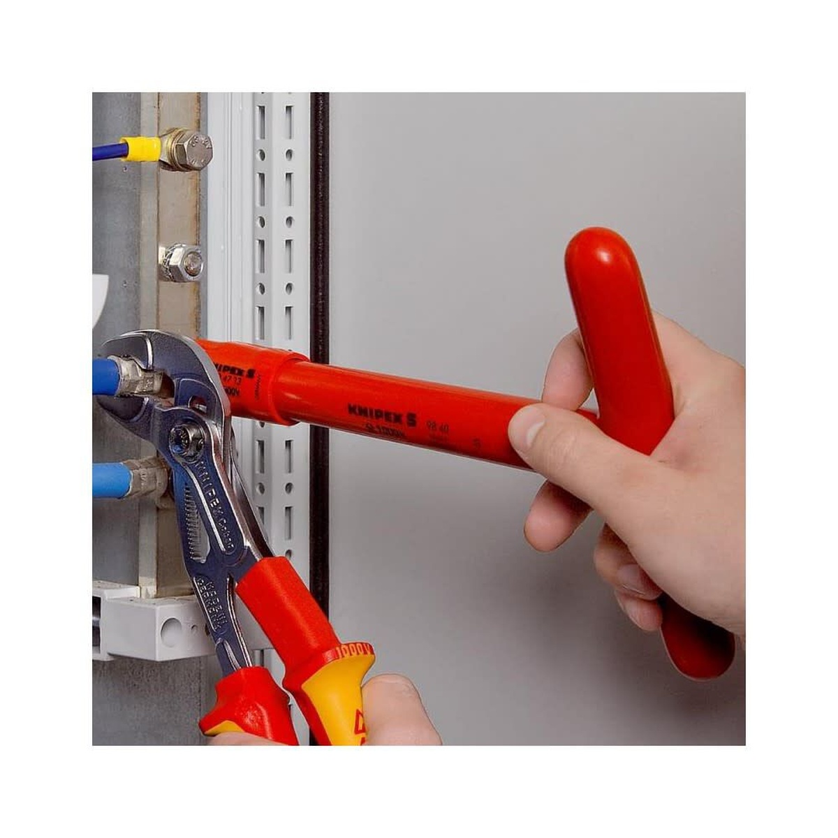 Knipex Cobra VDE Hightech Water Pump Pliers 250mm tightening hardware in an electrical panel with insulated handles for live-work protection