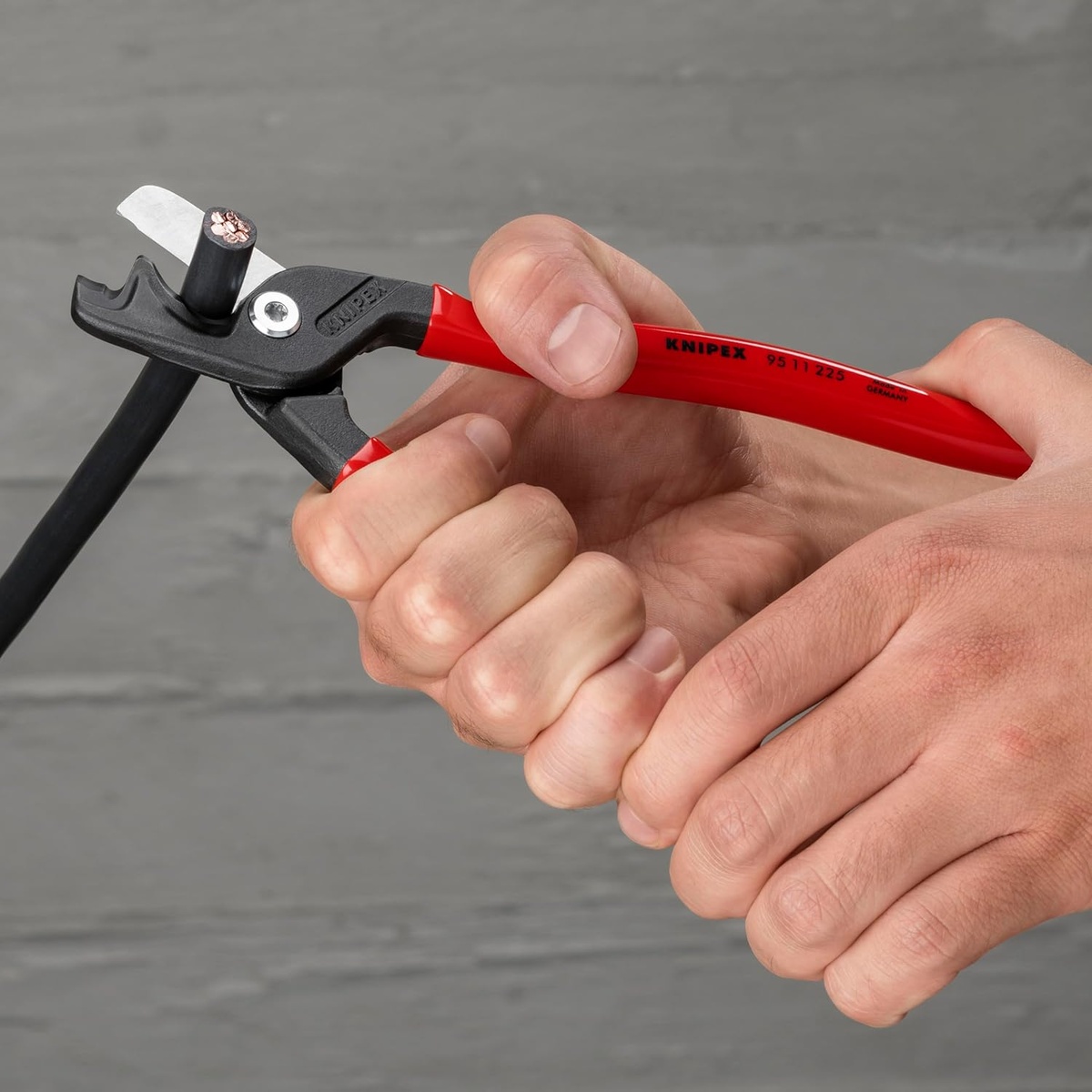 KNIPEX Tools 95 11 225 SBA StepCut XL Cable Shears cutting insulated electrical cable by hand in a work setting