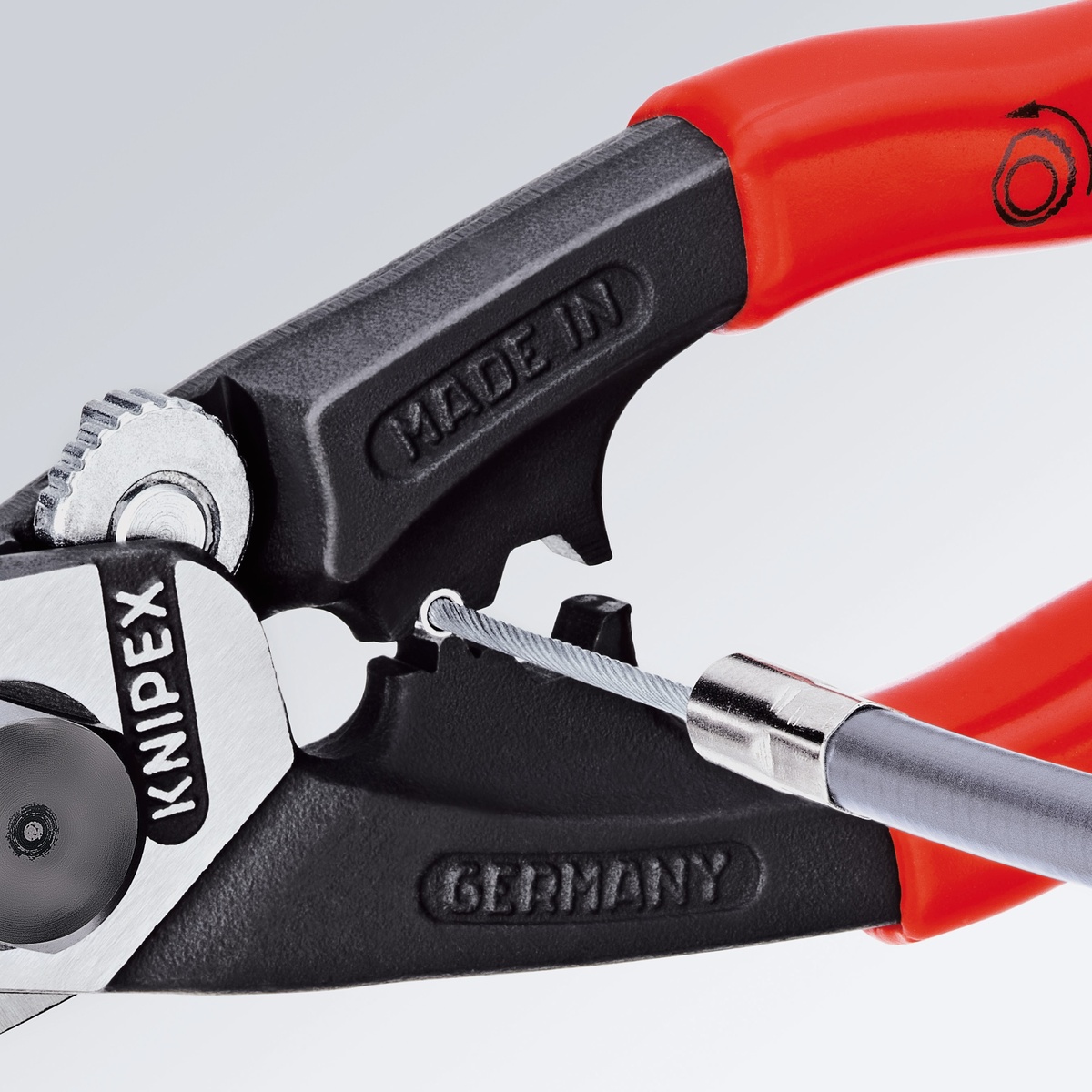 Knipex wire rope cutting pliers showing compact head and cable positioning for controlled one-handed use