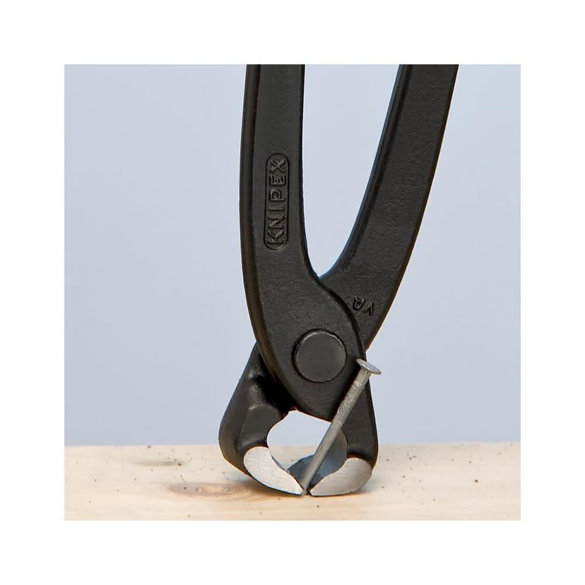 Knipex concreter nipper pulling a nail from wood on a jobsite-style work surface