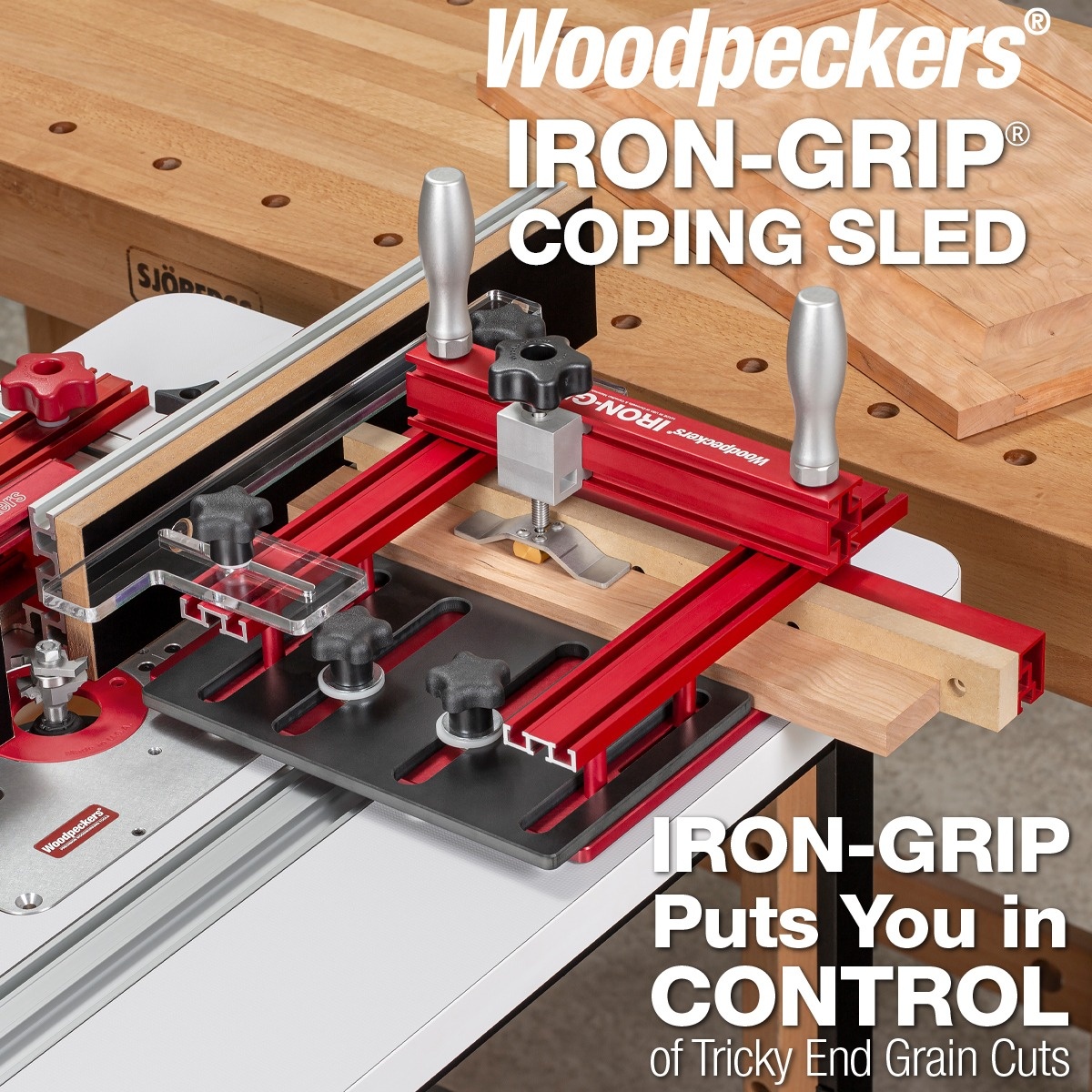 Woodpeckers Iron-Grip Clamp Upgrade for the Woodpeckers Coping Sled guiding a narrow board across a router table fence during end-grain coping work