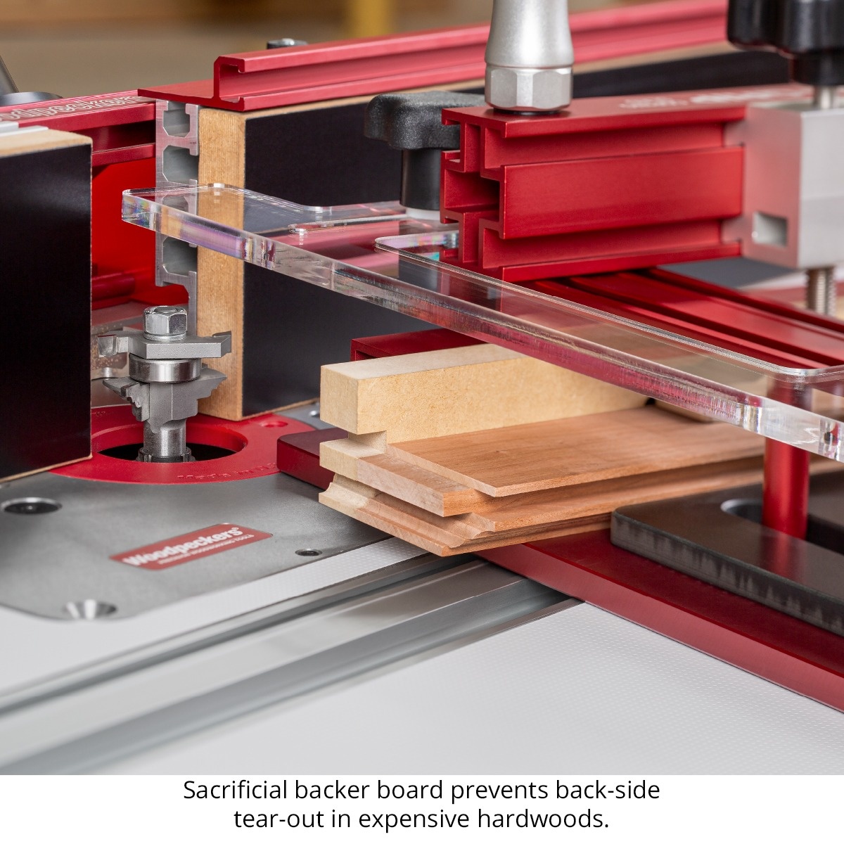 Woodpeckers Iron-Grip Clamp Upgrade using a sacrificial backer board on hardwood stock at a router table for cleaner end-grain cuts