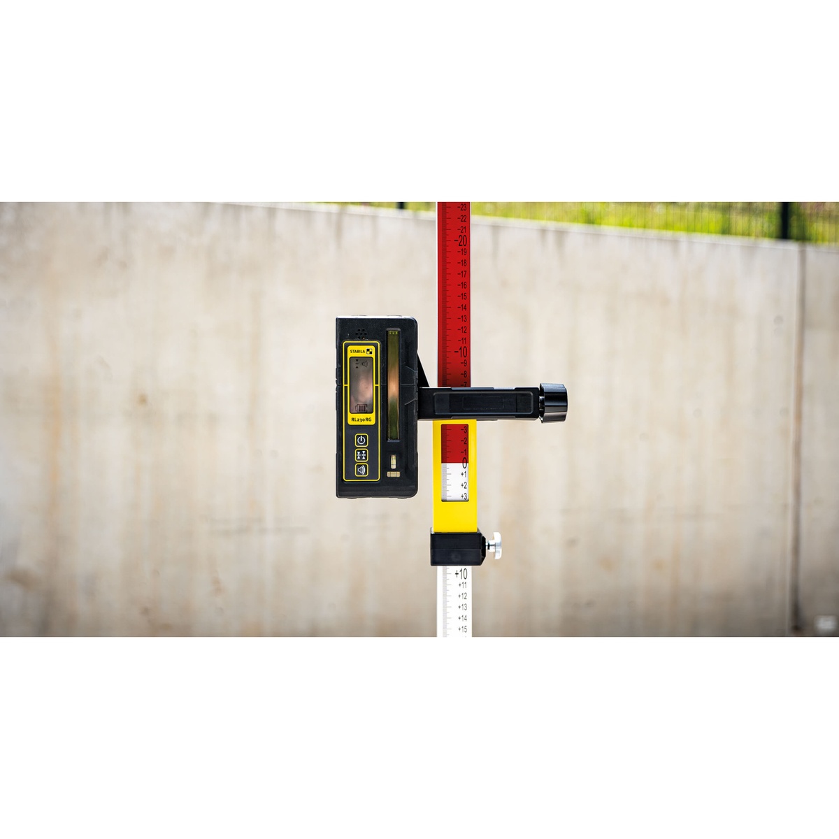 Stabila RL 230 RG Line Receiver mounted on a grade rod for construction layout and elevation checking on a concrete jobsite