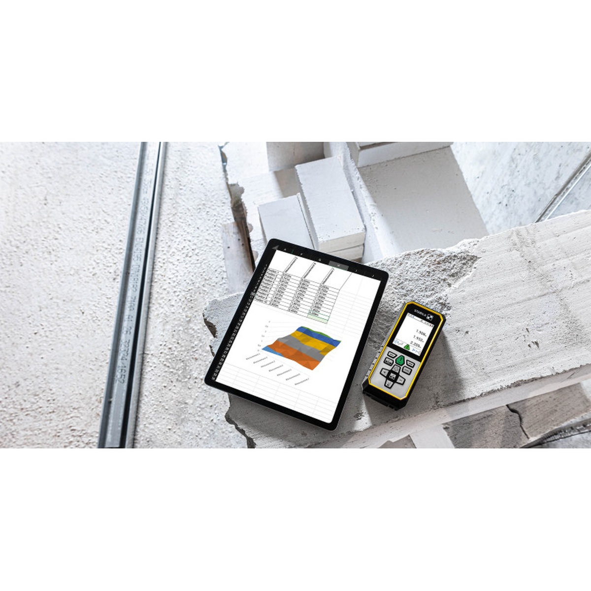 Stabila LD 530 BT 3.7V Battery Laser Distance Measurer with Bluetooth next to a tablet for digital measurement transfer on a masonry jobsite