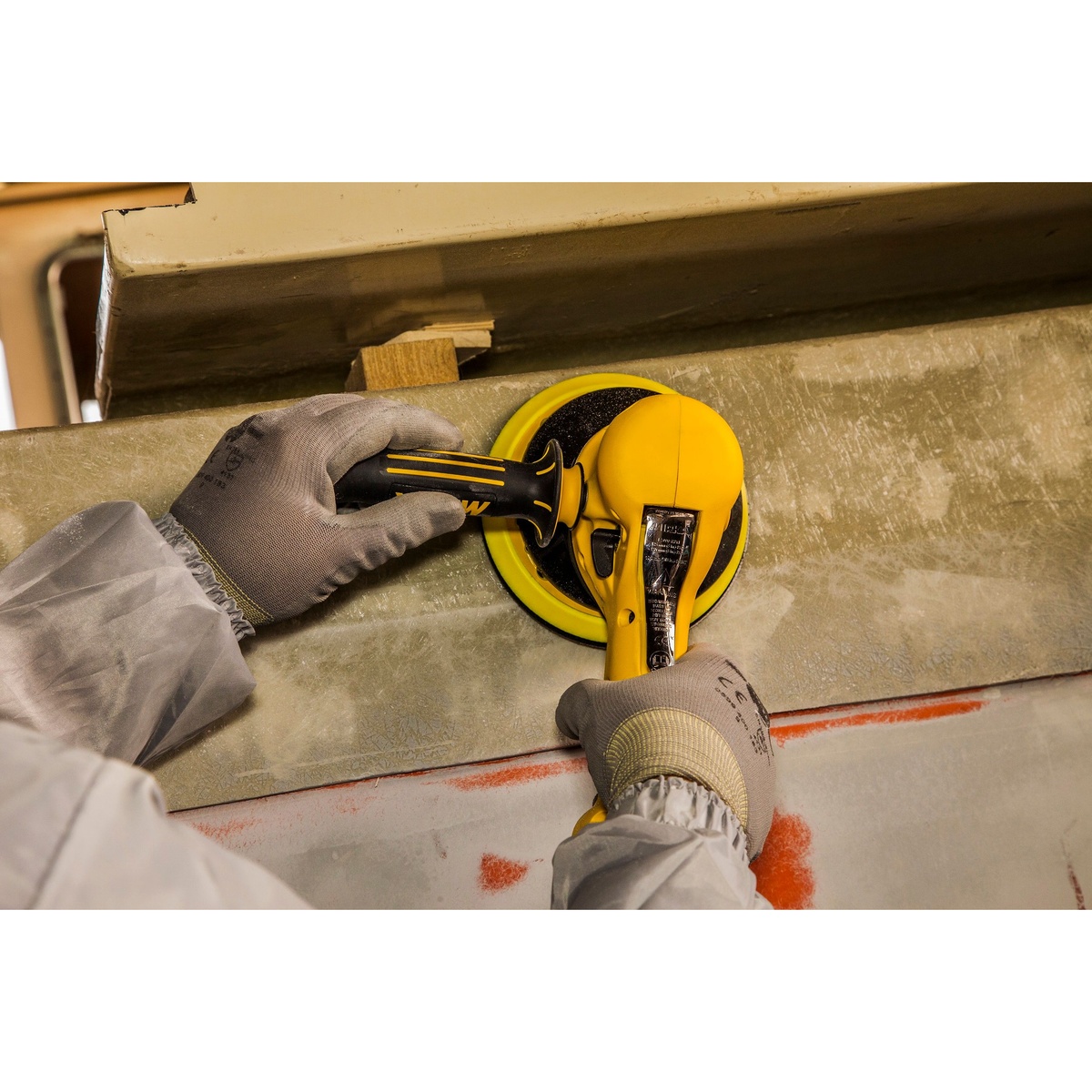 Mirka MR-610TH Two-Handed Vac-Ready Sander sanding a large panel surface during aggressive material removal in a shop setting
