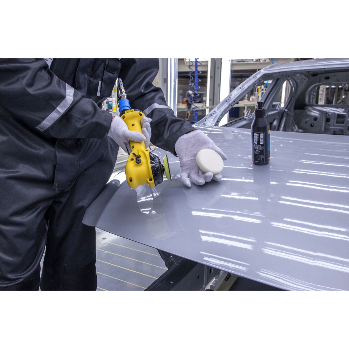 Mirka MROP-312TH 3 inch Two-Handed Orbital Polisher positioned for controlled polishing on an automotive hood in a production environment