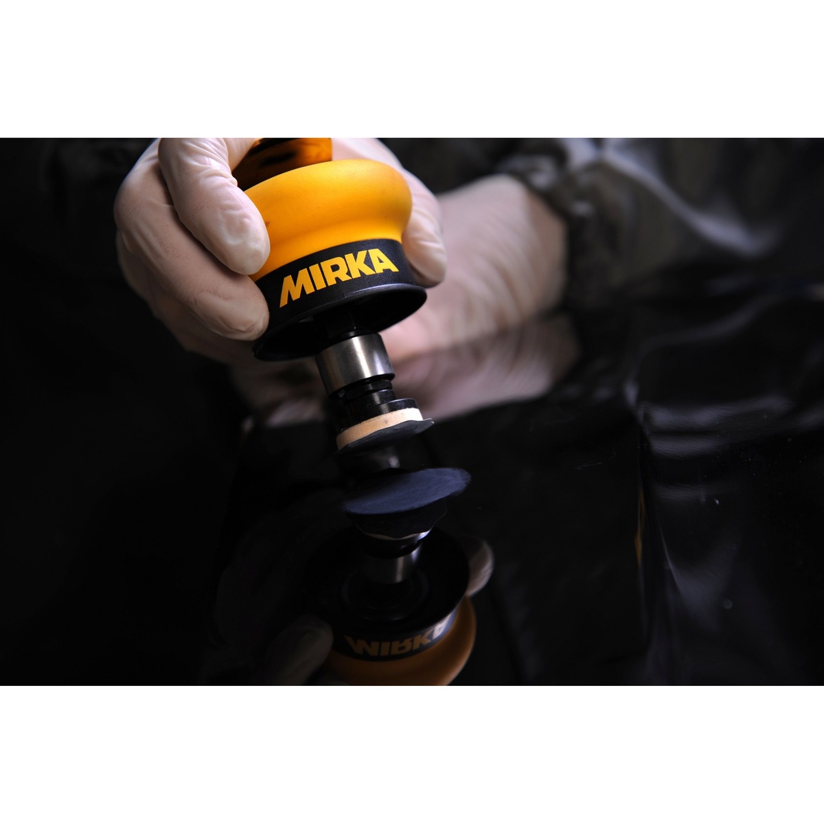 Mirka MROS150 1.25 inch Orbital Finish Sander sanding a small glossy repair area during detailed finishing work
