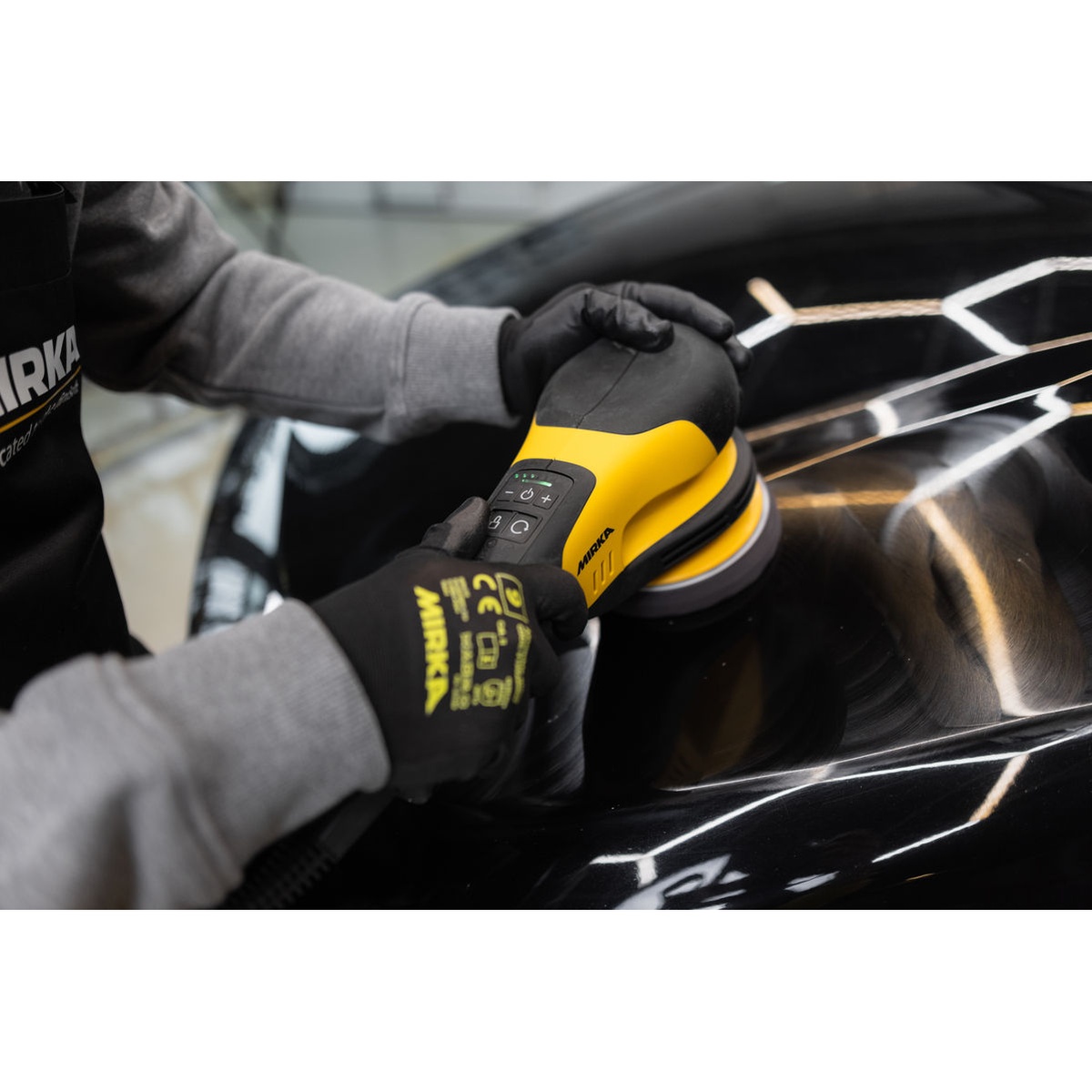 Mirka POLAROS RP 600X 6 Inch Electric Rotary Polisher polishing an automotive body panel during detailing and surface finishing work