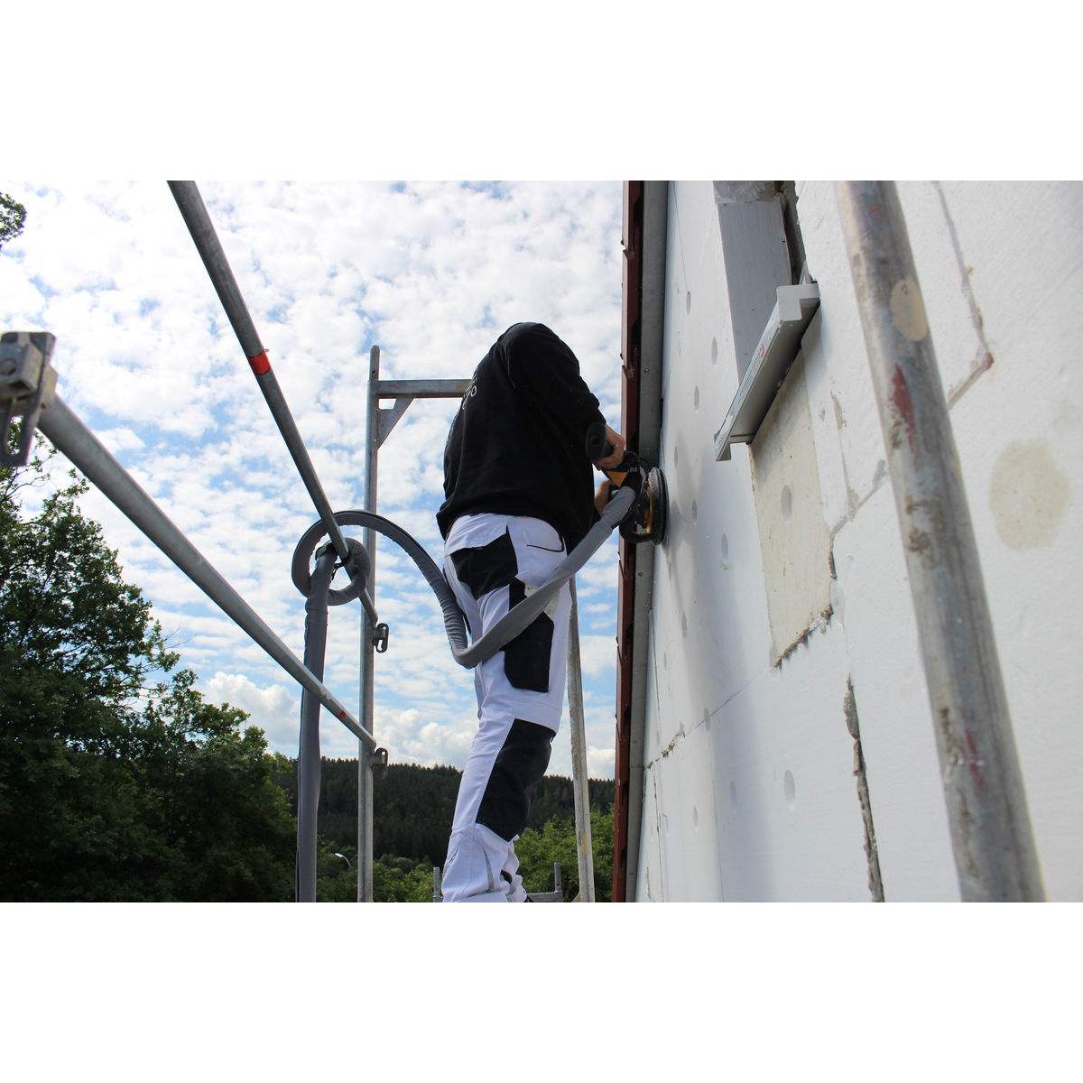 Mirka IRIDIUM 9 inch Grip 9H Styro sanding disc used on exterior polystyrene wall panels during surface leveling on scaffolding