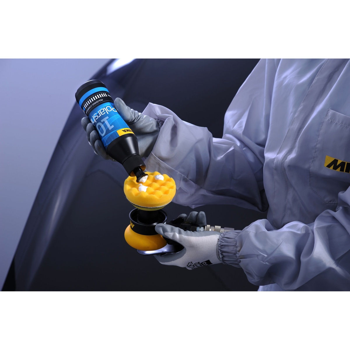 Mirka Polarshine 10 Polishing Compound being applied to a polishing pad for automotive paint correction on a vehicle panel