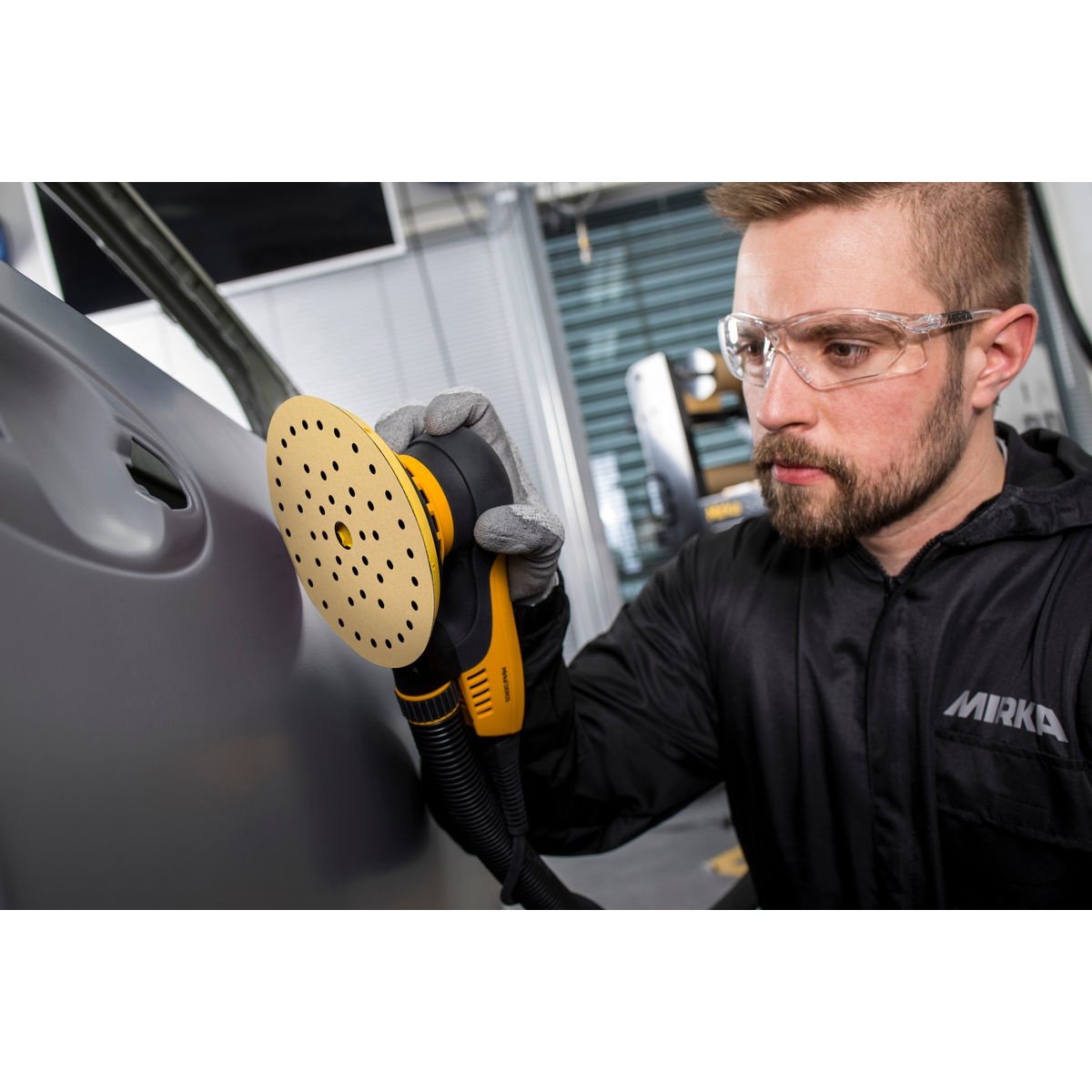 Mirka GOLD Multifit 5 in Grip Sanding Discs used on an orbital sander for curved automotive panel sanding and surface preparation