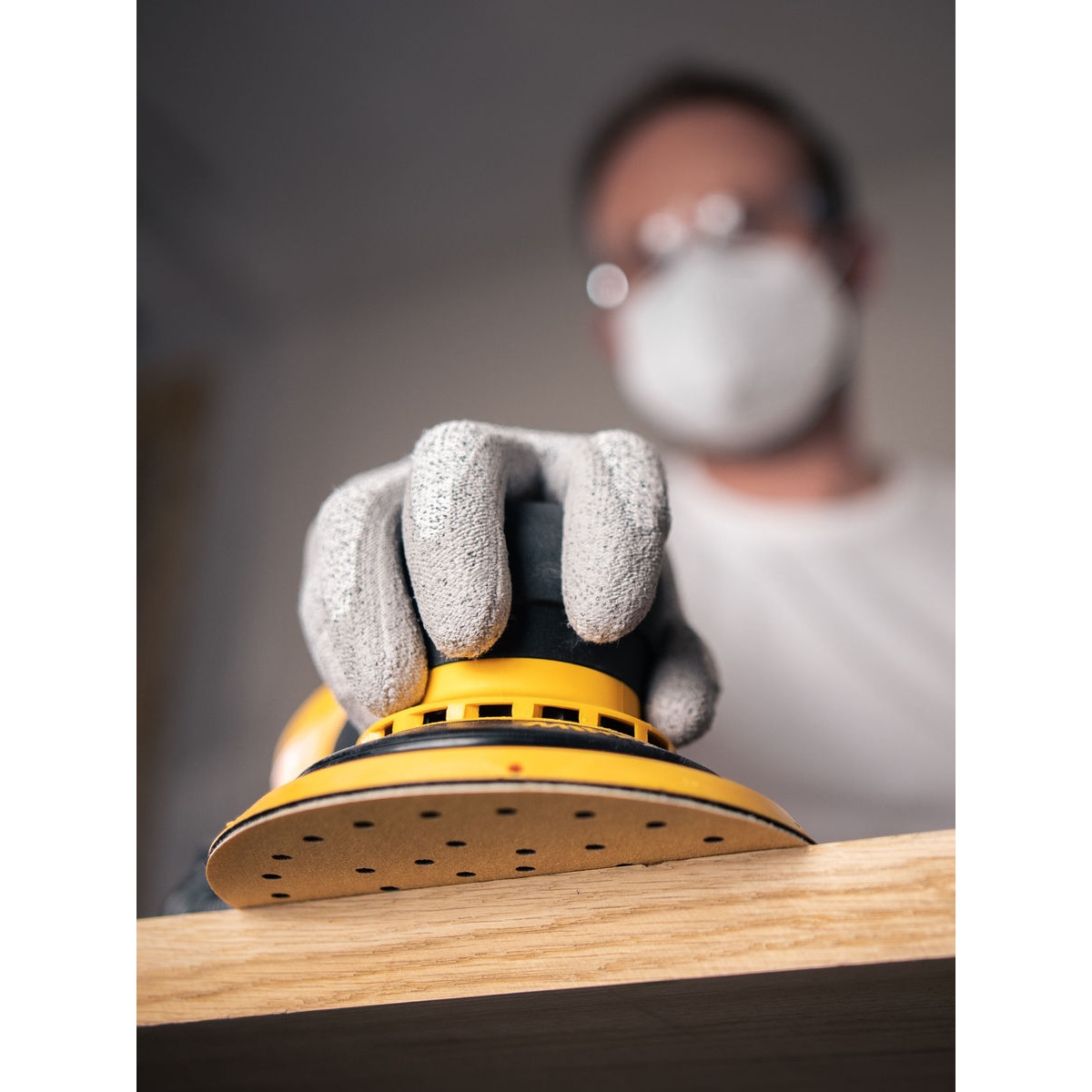 Mirka GOLD Multifit 5 in Grip Sanding Discs sanding a wood surface with a 5 inch orbital sander for rough stock removal and surface leveling