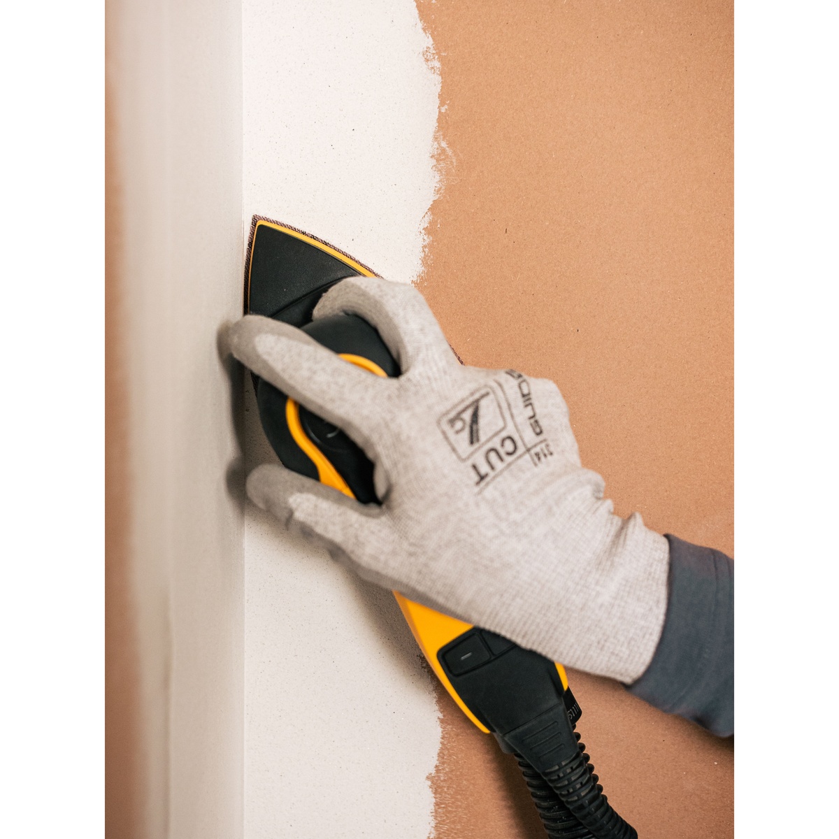Mirka Abranet 4 Inch x 6 Inch x 6 Inch P80 Grit Grip Triangle Sheet sanding a painted inside corner with a delta sander during wall surface preparation