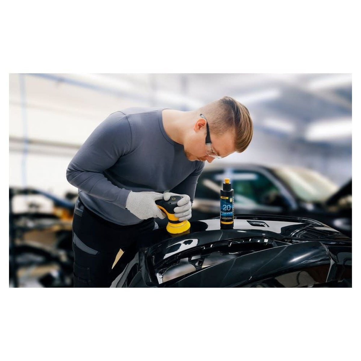 Mirka Polarshine 20 1L Polishing Compound used during automotive paint correction on a glossy black vehicle panel in a workshop setting