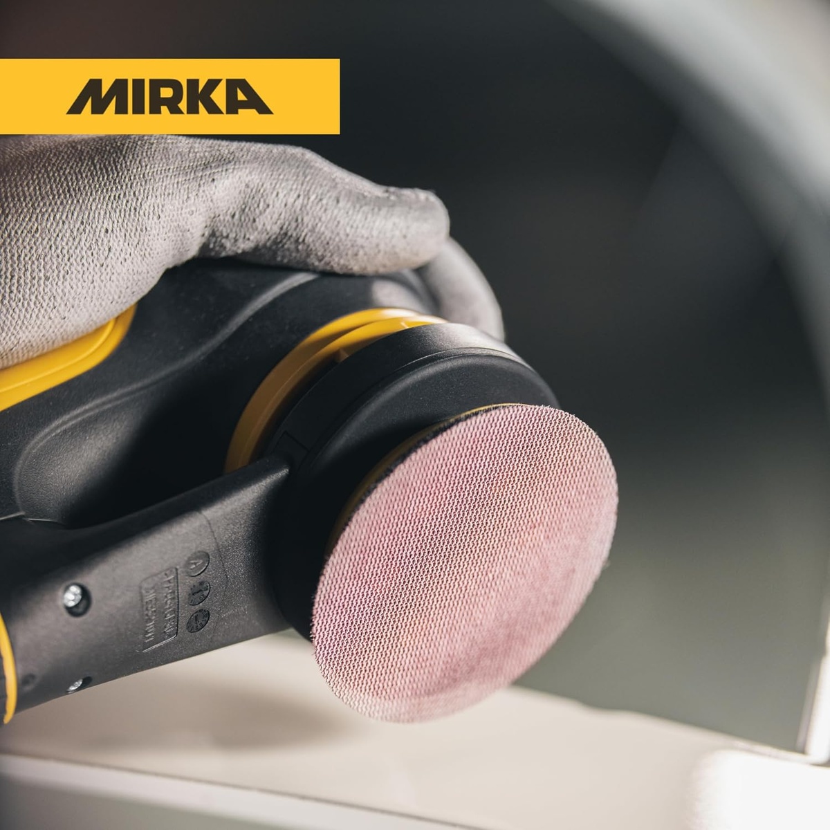 Mirka Abranet 9A-203-320 mesh sanding disc on a 3 inch orbital sander during detail sanding on a coated work surface in a shop setting