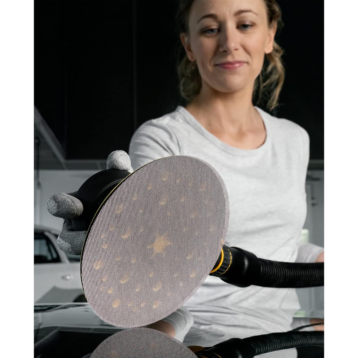 Mirka Abranet 6 Inch Assortment Disc Pack 10 Pieces used with a vacuum sanding pad during surface finishing on an automotive panel
