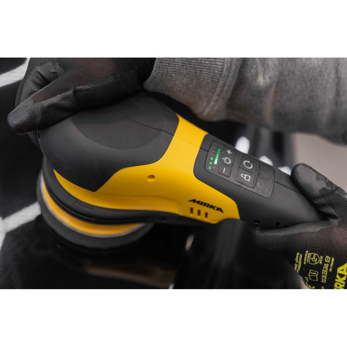 Mirka POLAROS RP 600X 6 inch rotary polisher control panel and grip during polishing on a dark coated surface