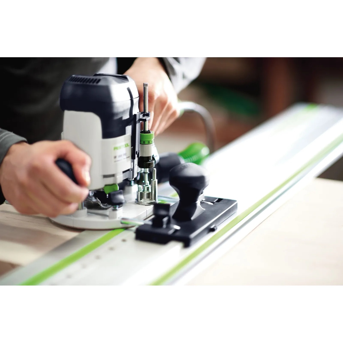 Festool 32 mm Hole Drilling Guide Rail FS1400/2-LR 32 guiding a Festool router while drilling a row of cabinet holes in a wood panel during shop setup
