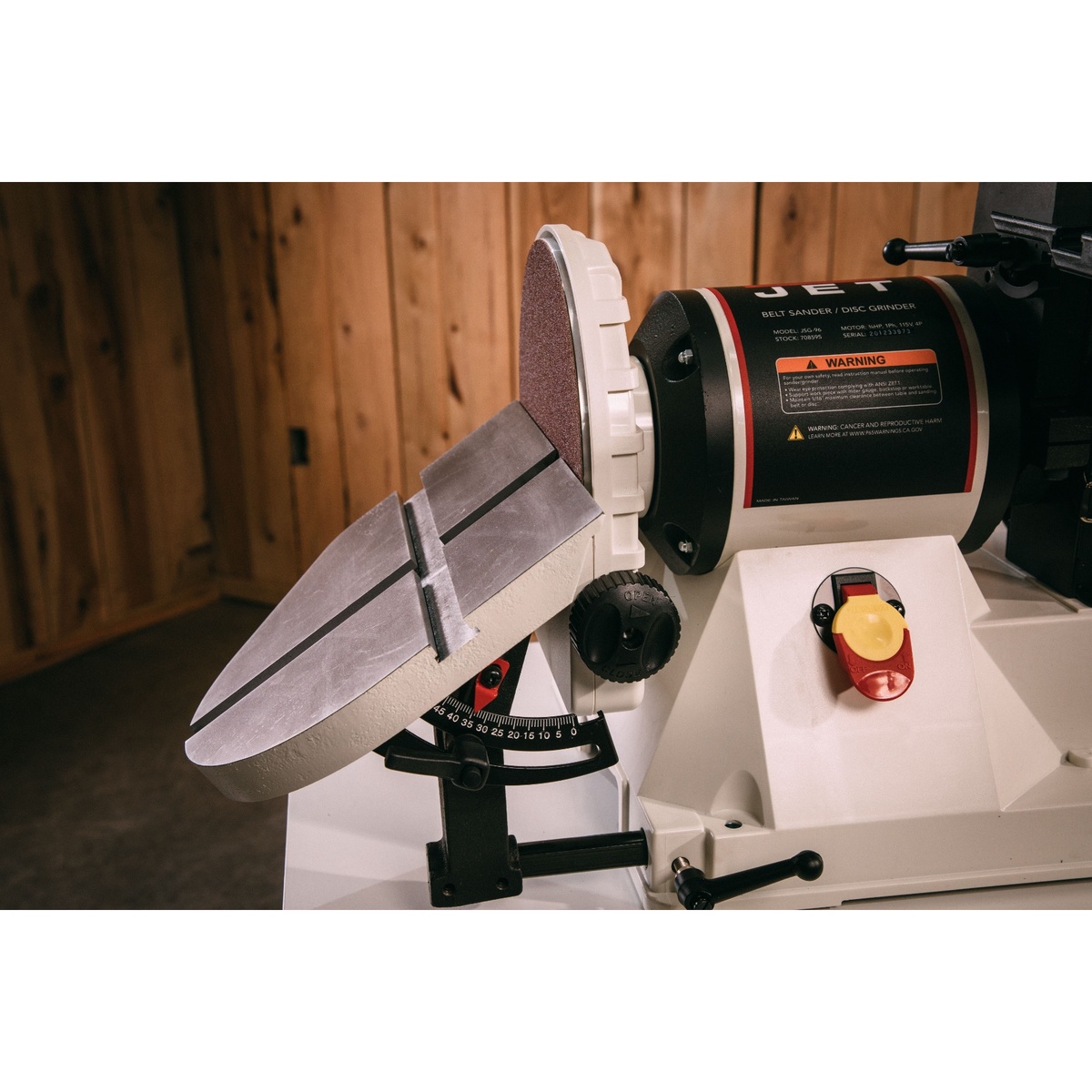 Jet 708597K JSG-96CS 9 inch disc sander table tilted for angle sanding in a woodworking shop environment