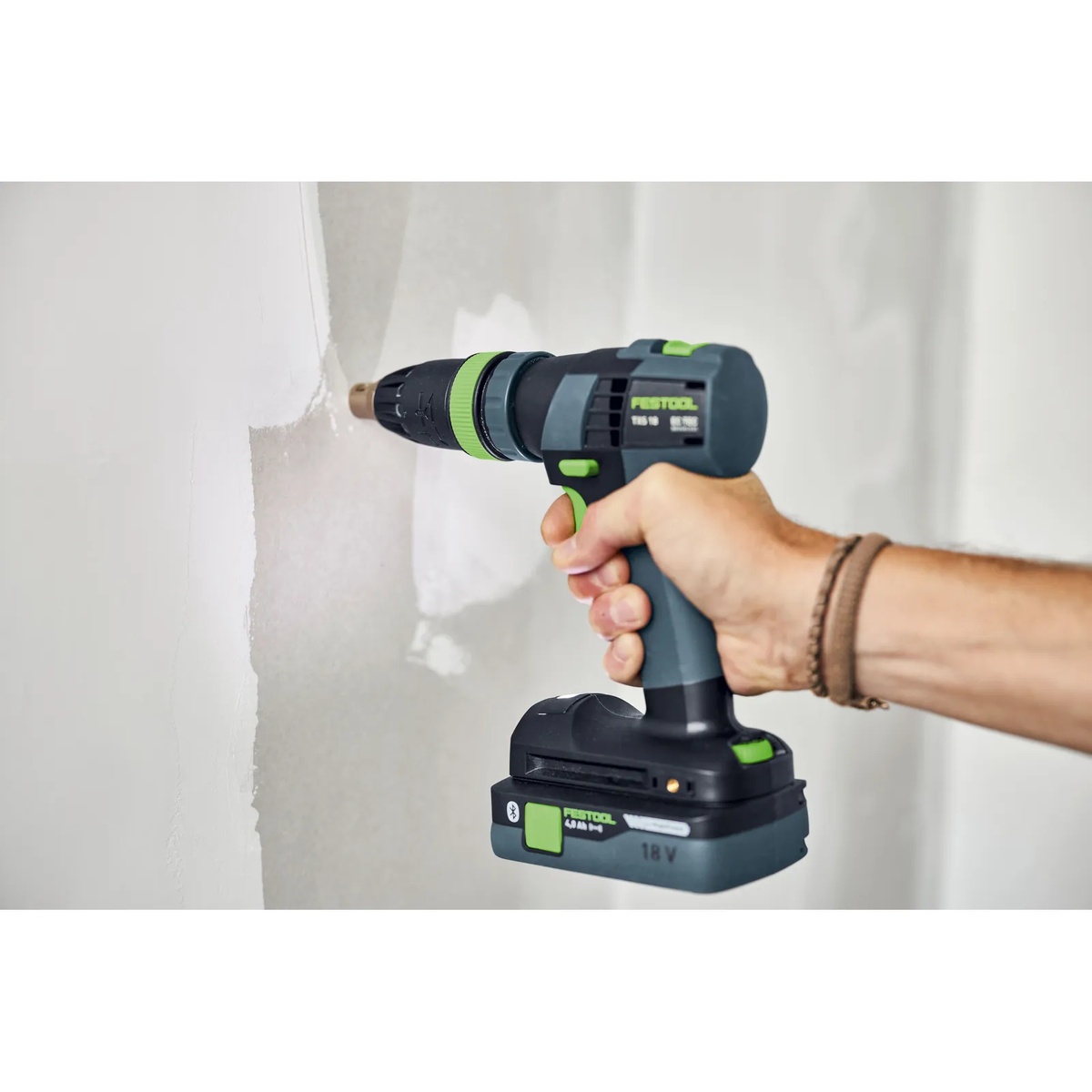 Festool 493539 FastFix Depth Stop Chuck installed on a Festool drill driving a screw flush into drywall during interior wall work