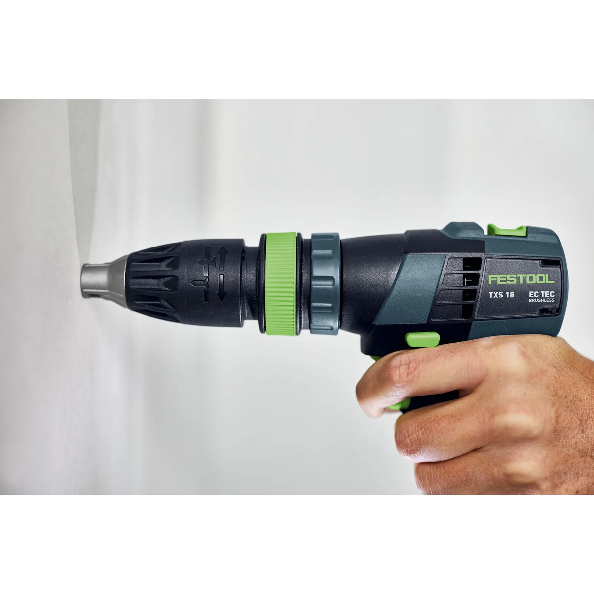 Festool 493539 FastFix Depth Stop Chuck on a Festool drill positioned against drywall, showing the narrow tip for clear visibility at the screwdriving point