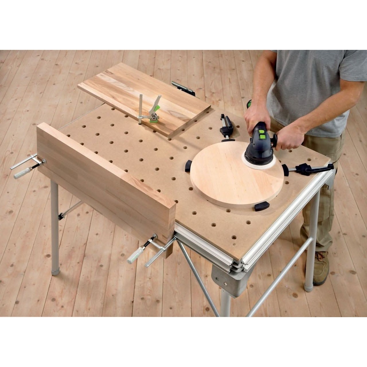 Festool 488030 Clamping Elements, 2-pack securing wood workpieces on a Festool MFT table during sanding in a workshop setting