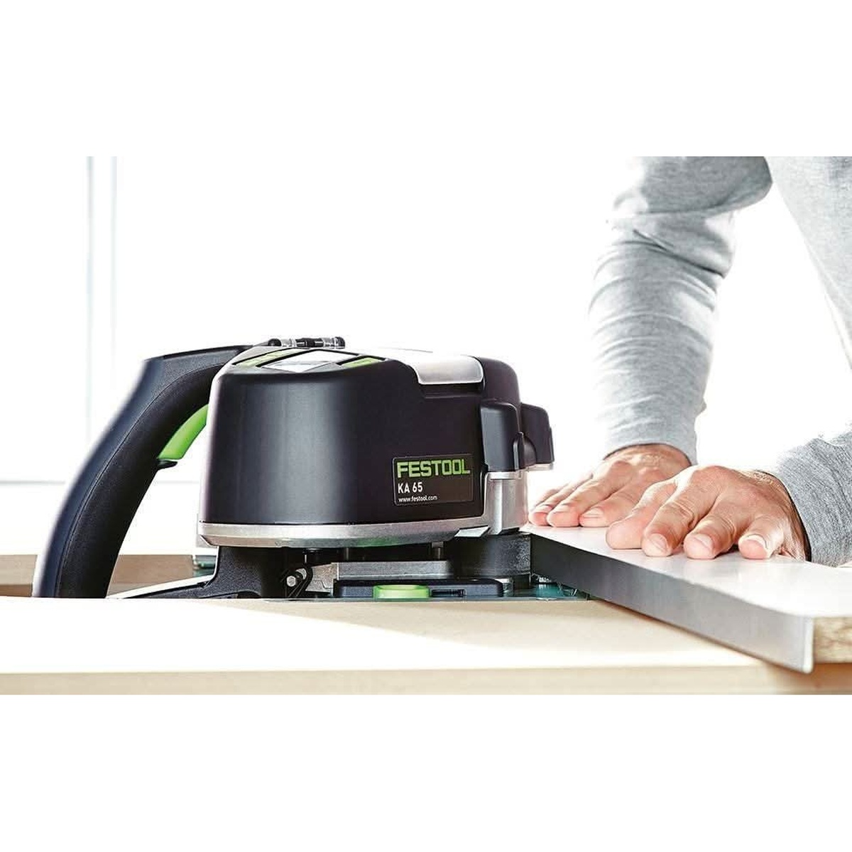 Festool 500869 MFT/3 CONTURO Edge Bander Table with CONTURO edge bander running edge banding along a straight panel edge on a bench