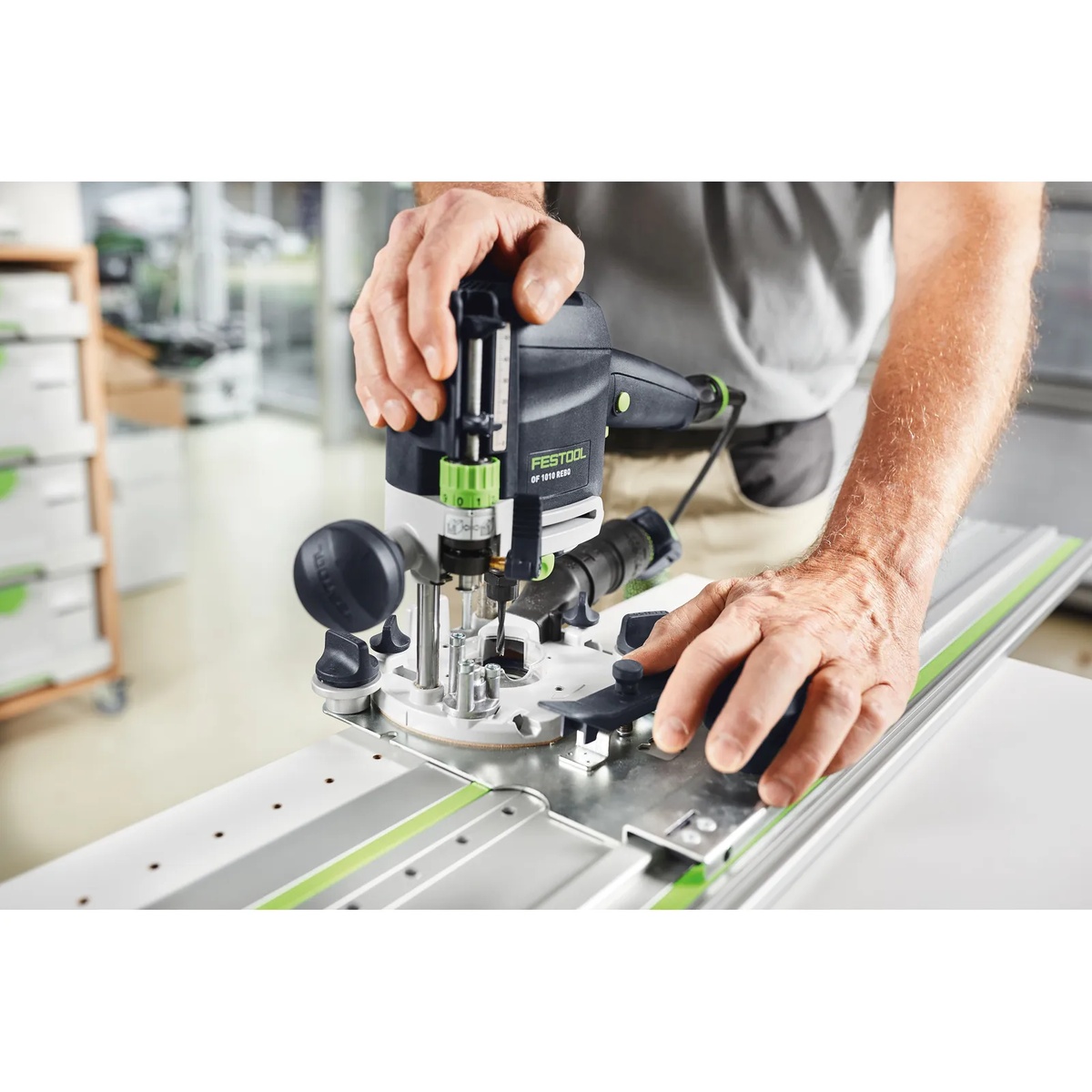 Festool 491622 32mm Hole Drilling 95 inch Guide Rail supporting a Festool router on a long workpiece for cabinet panel boring and accurate rail-guided work
