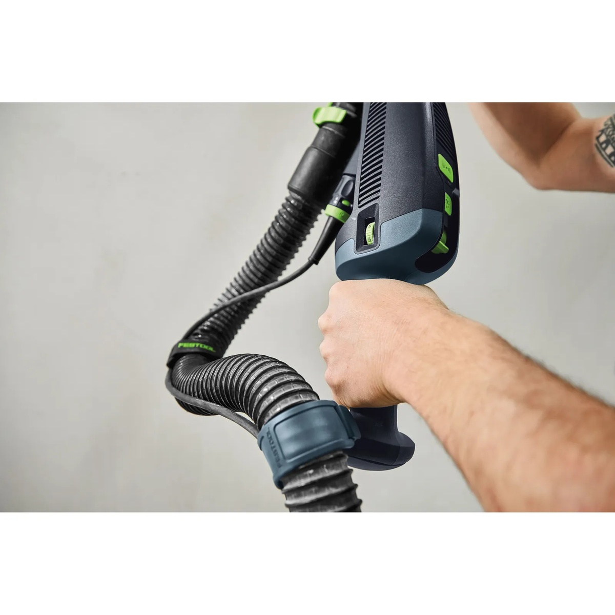 Festool 577101 CT AutoClean Antistatic Hose connected to a drywall sander during wall sanding, showing flexible hose movement in a finish sanding application