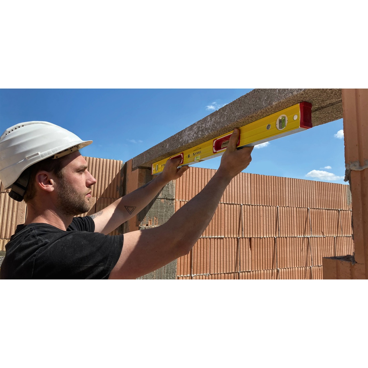 Stabila 37816 48-inch & 16-inch Type 196 2-Piece Spirit Level Set used under a concrete lintel during masonry layout work