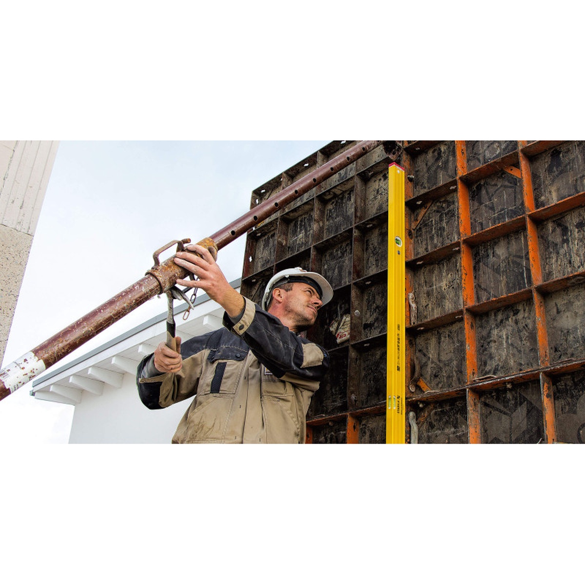 STABILA Type 96 M Mag Jamber Set magnetic spirit level used hands-free on a jobsite wall form for fast plumb checks