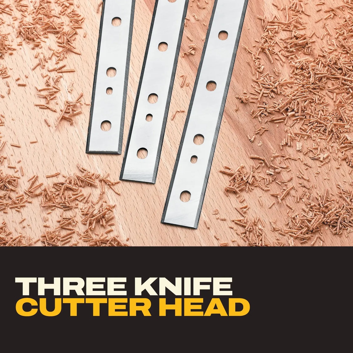 Close-up of the DeWALT DW735X 13-In. 3-Knife Two Speed Thickness Planer cutter knives on a wood surface with fresh planer shavings