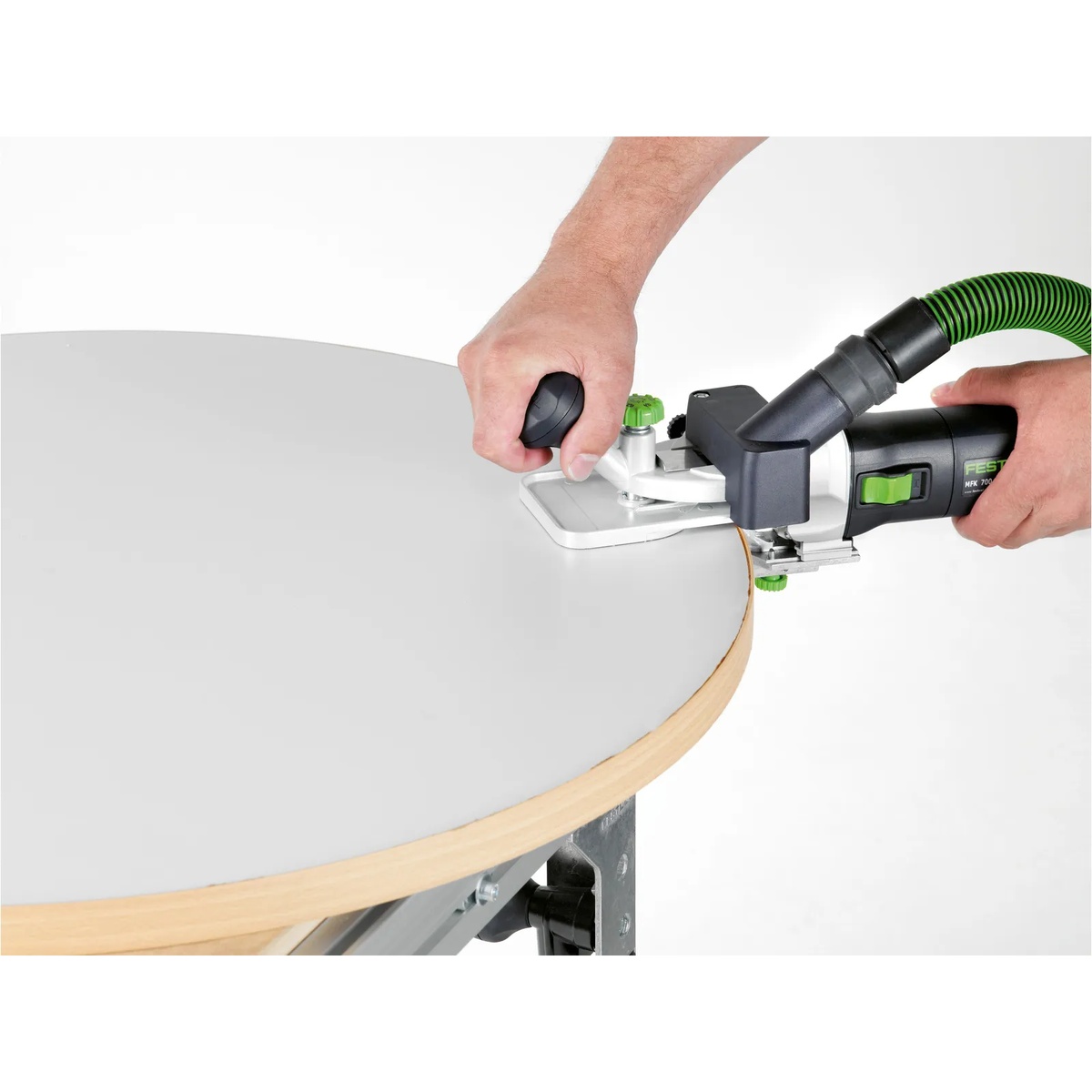 Festool 495165 1.5 Degree Horizontal Base MFK700 trimming edge banding around a curved tabletop edge during finishing work