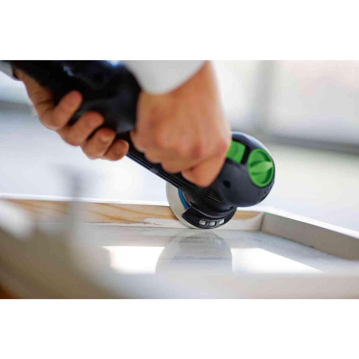 Festool 576263 RO 90 DX FEQ-Plus Rotex Sander in use on a curved wood workpiece during aggressive sanding and surface preparation