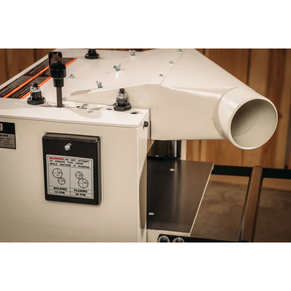 Jet JPM-13CS 13 inch Closed Stand Planer / Molder angled 4 inch dust port on the machine in a woodworking shop