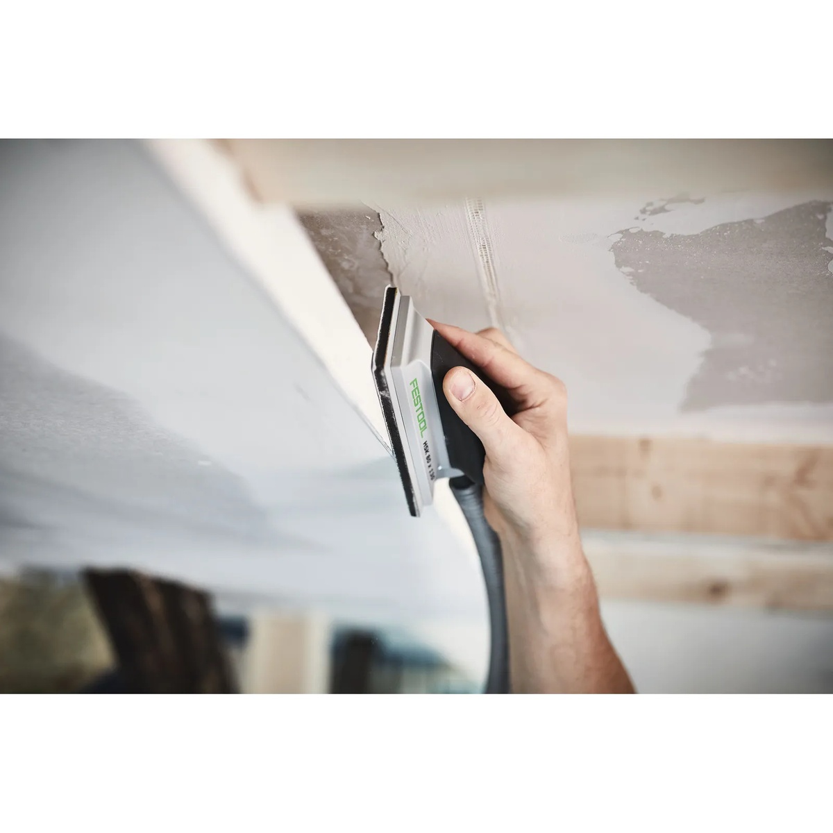 Festool 496962 Hand Sanding Block 80mm X 130mm sanding a ceiling corner by hand during drywall finishing and surface prep