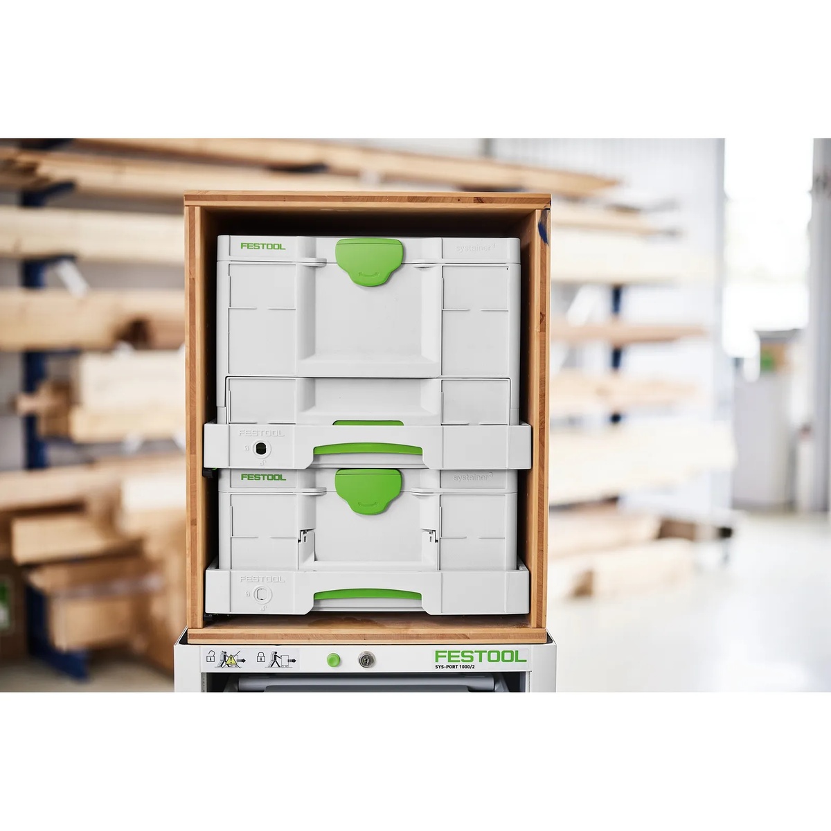 Festool SYS-AZ drawer system holding Festool Systainers inside a wooden storage cabinet in a workshop environment