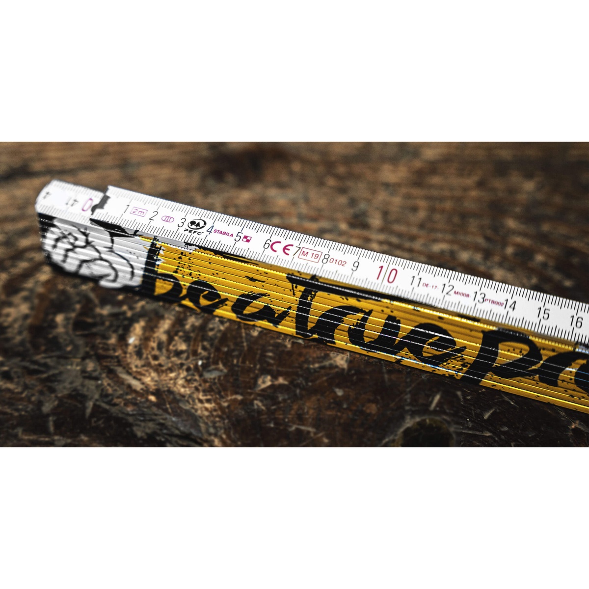 Stabila 80015 Engineer's Folding Ruler opened on a workbench showing engineer scale markings for plan measurement and jobsite layout