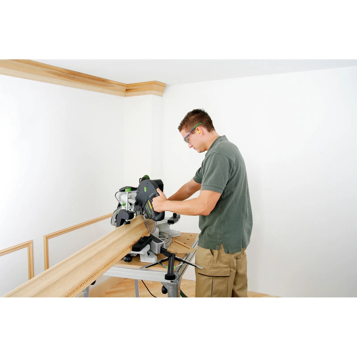 Festool 495465 Multifunction Table MFT KAPEX supporting a Kapex miter saw while cutting long interior trim in a finished room