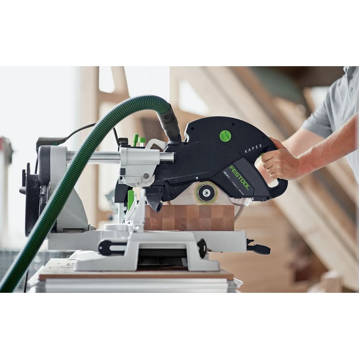 Festool multifunction table paired with a Kapex saw during a crosscut, showing stable support and work surface under the saw