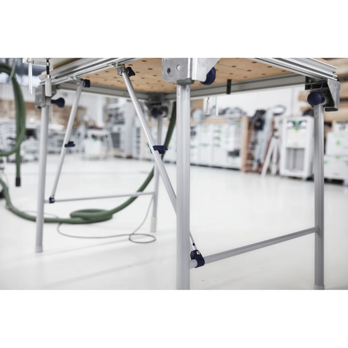 Festool 495502 Cross Members mounted between MFT table legs and tabletop for added support in a workshop