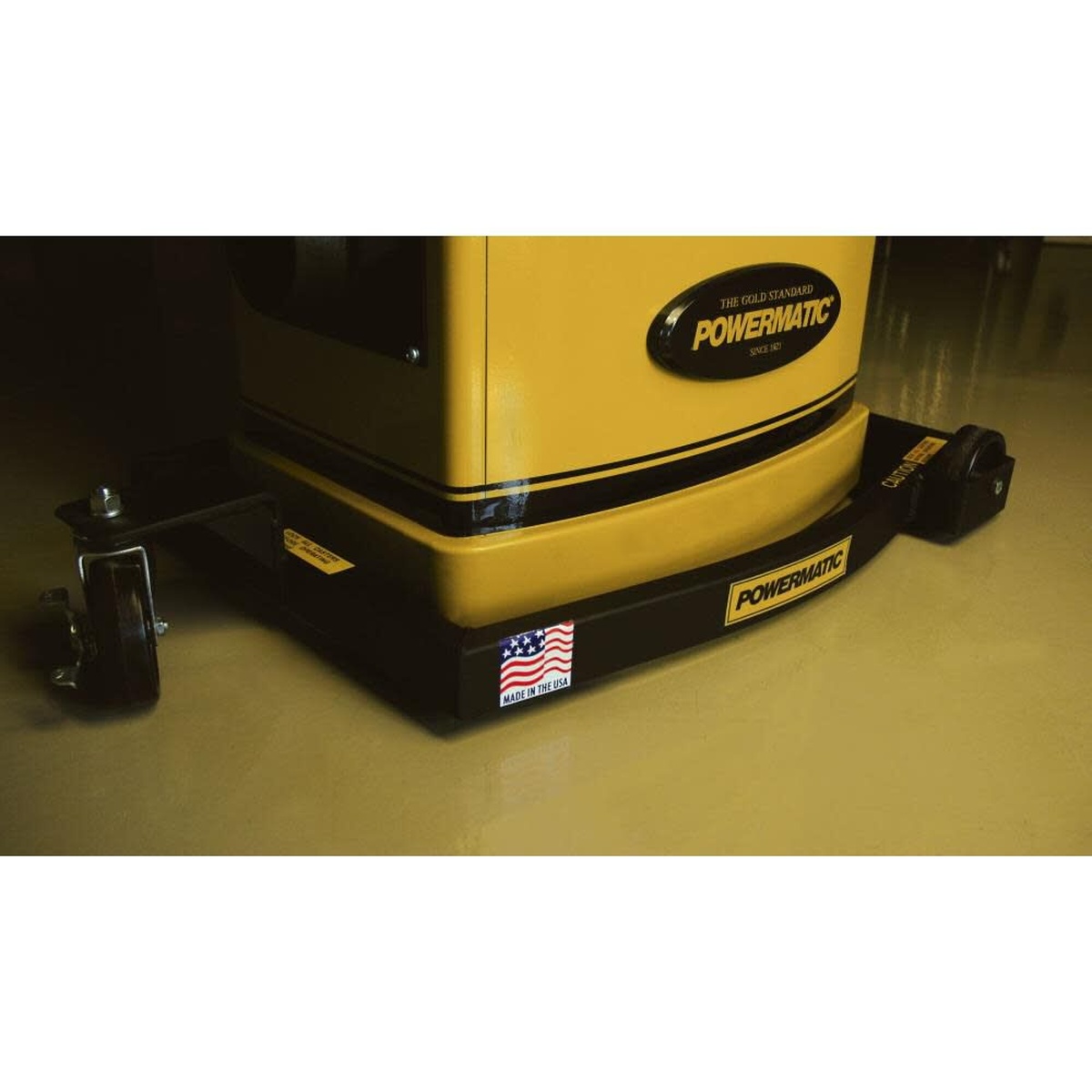 Powermatic 2042374 Mobile Base for 54A/54HH Jointers installed under a Powermatic jointer in a woodworking shop with the caster and frame visible