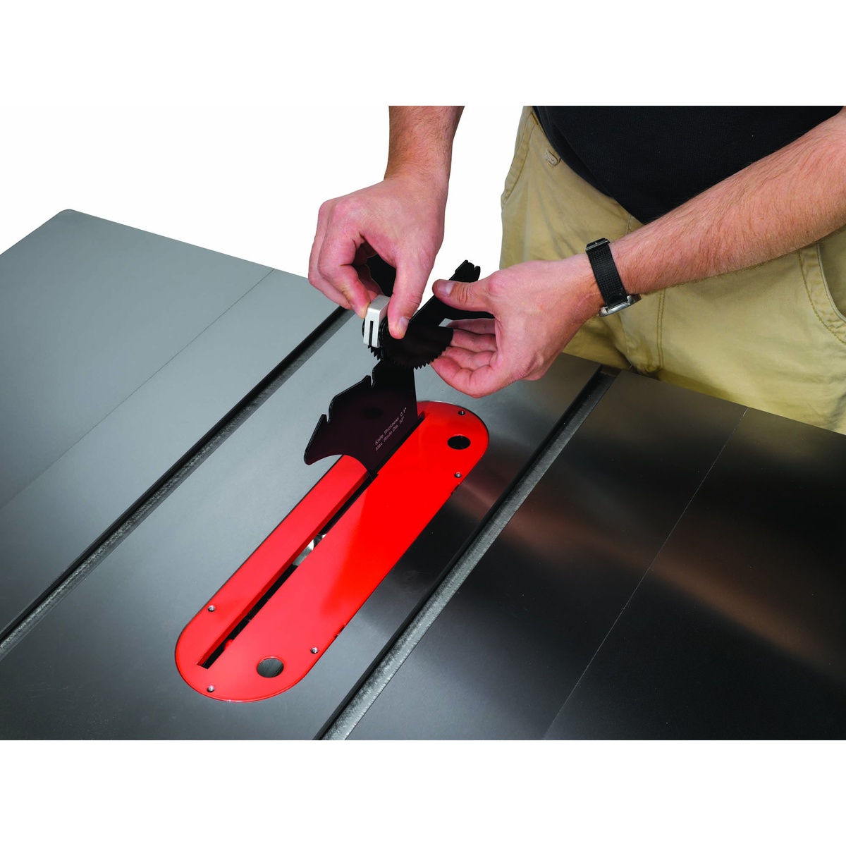 Jet 708675PK Deluxe Xacta SAW 3HP, 1Ph, 50 inch Rip table saw with the quick release riving knife being adjusted on the cast iron table during blade setup in a woodworking shop