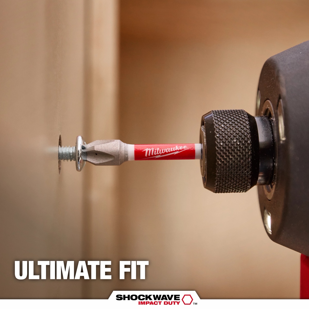 Milwaukee 48-32-4004 Shockwave 32-Piece Impact Driver Bit Set driving a screw into a panel with an impact driver during fastening work