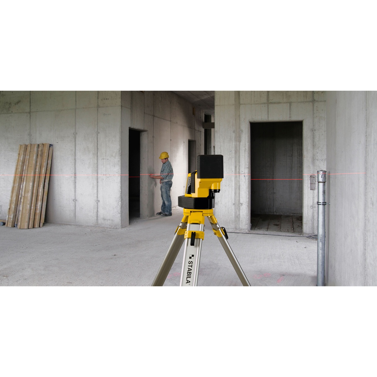 Stabila 02180 LA 180L Layout Laser Level Set on a tripod projecting a horizontal red line across a concrete interior for layout and datum transfer