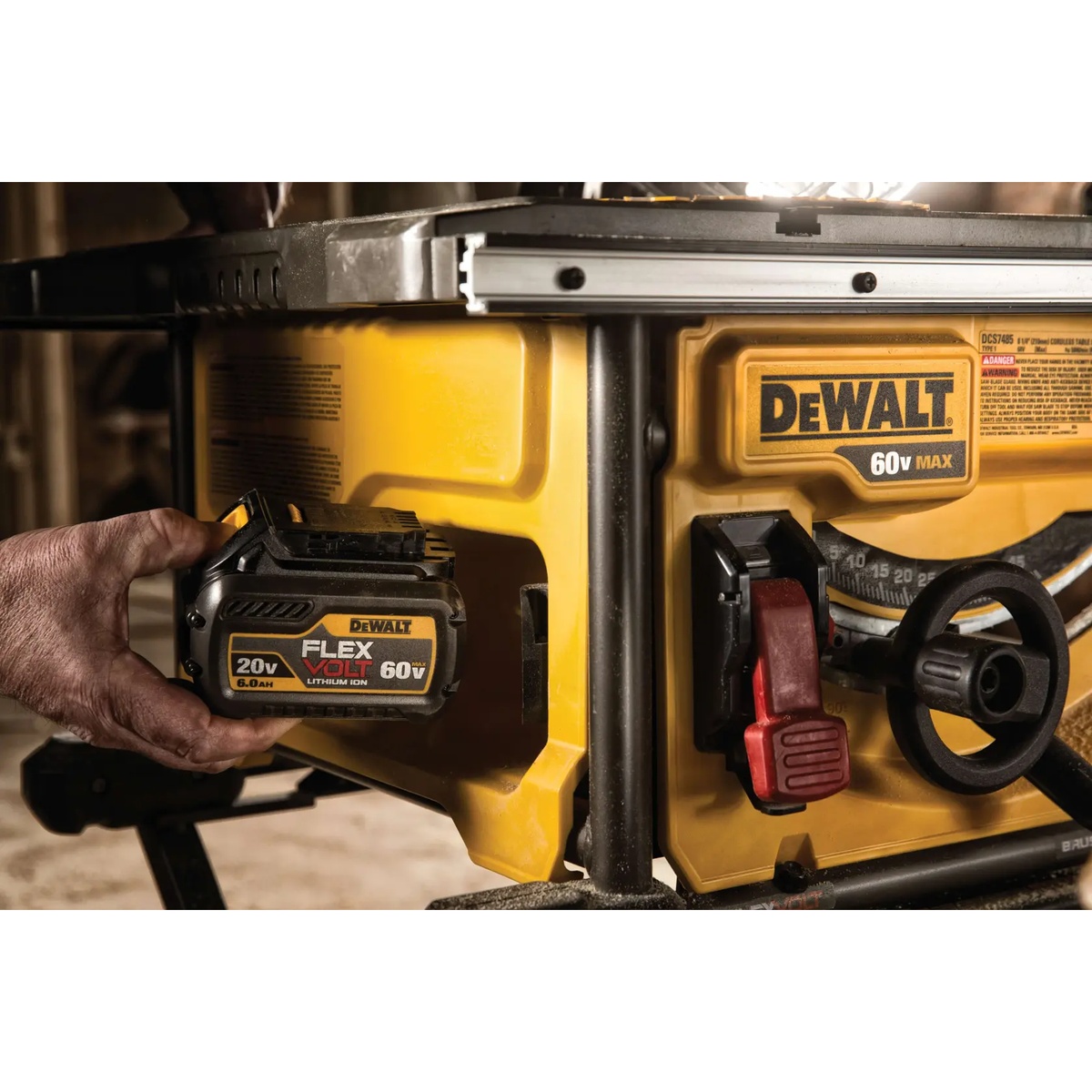 DEWALT DCS7485T1 FLEXVOLT 60V MAX 8-1/4 in. table saw battery installation close-up on a wood jobsite showing cordless power setup