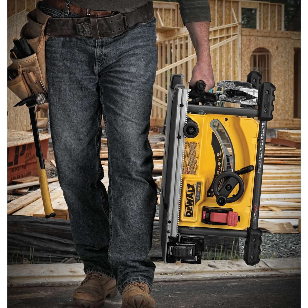 DEWALT DCS7485T1 FLEXVOLT 60V MAX 8-1/4 in. table saw being carried by a contractor on a framing jobsite for portable wood cutting work
