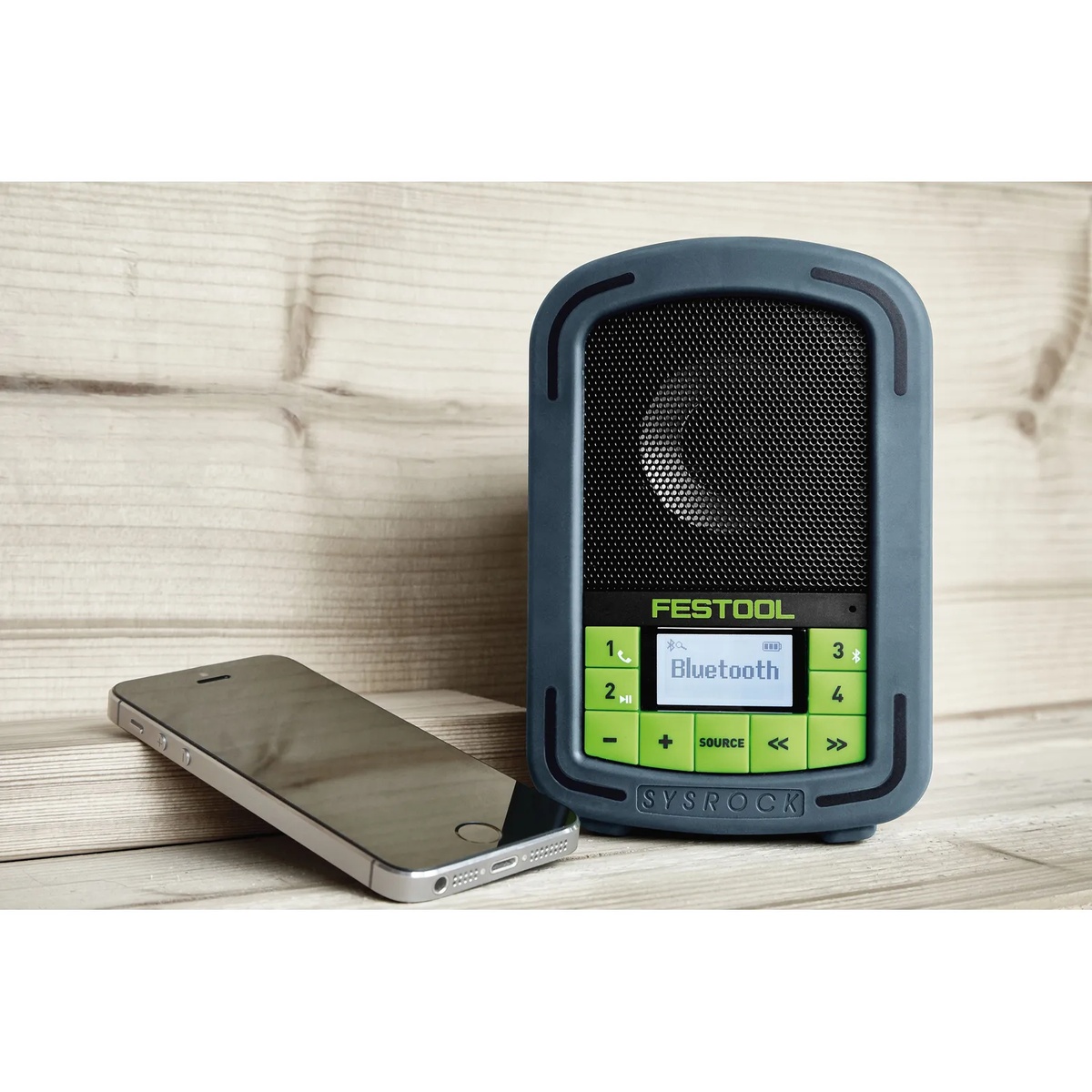 Festool 200184 BR10 SysRock Jobsite Radio paired with a smartphone on a wood shelf showing Bluetooth connection for wireless music streaming